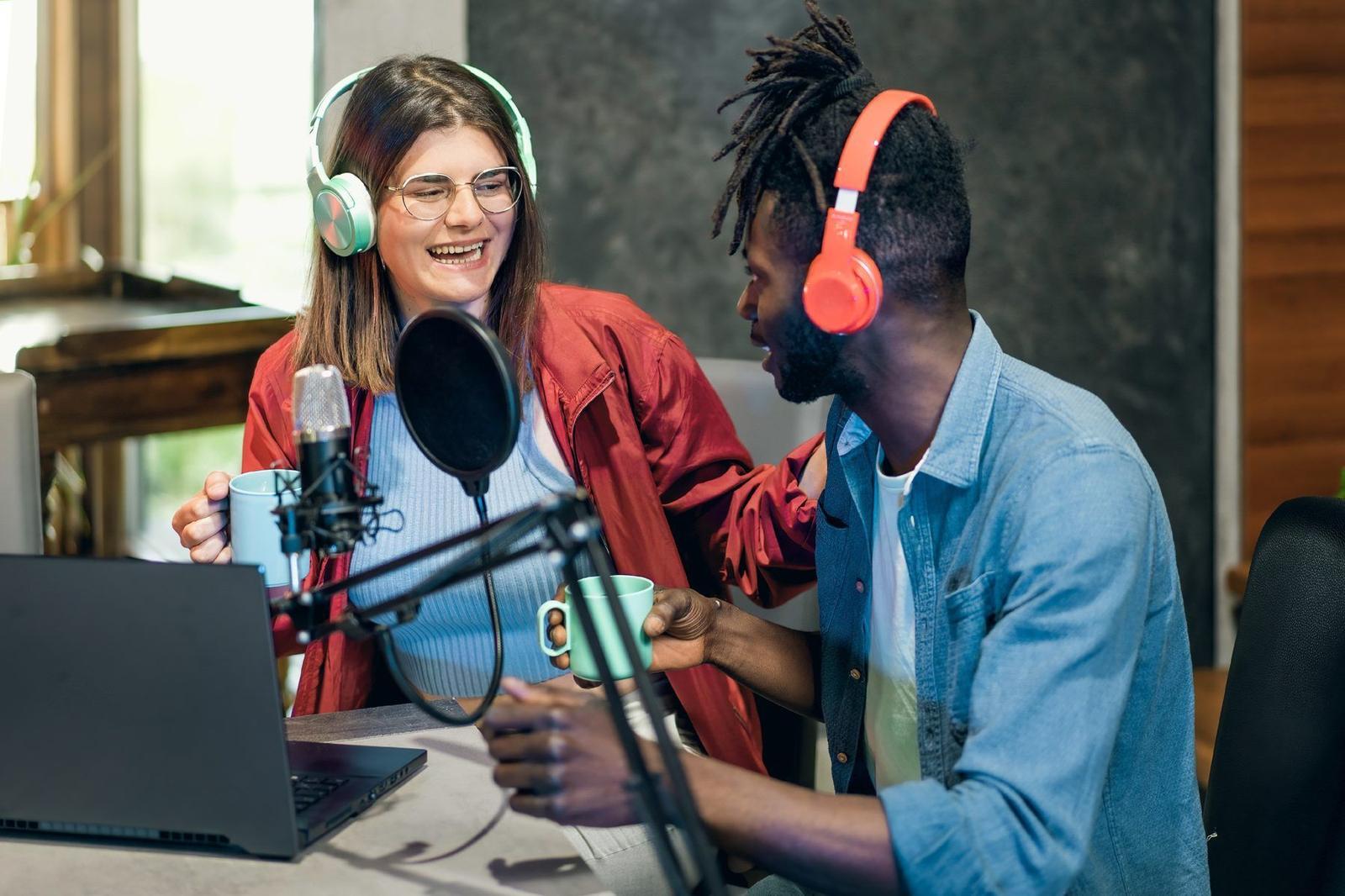 Two hosts recording a podcast together