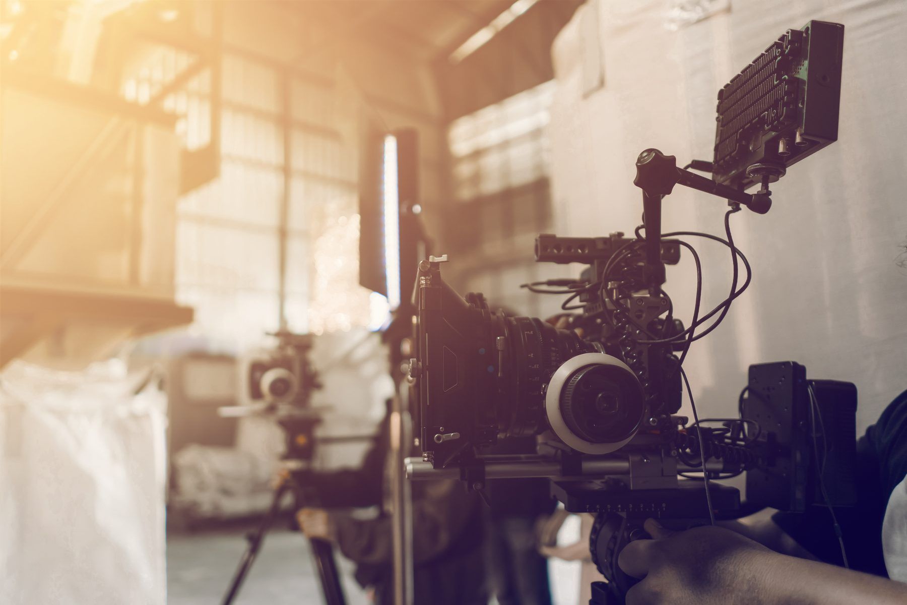 A film crew setting up lights on set