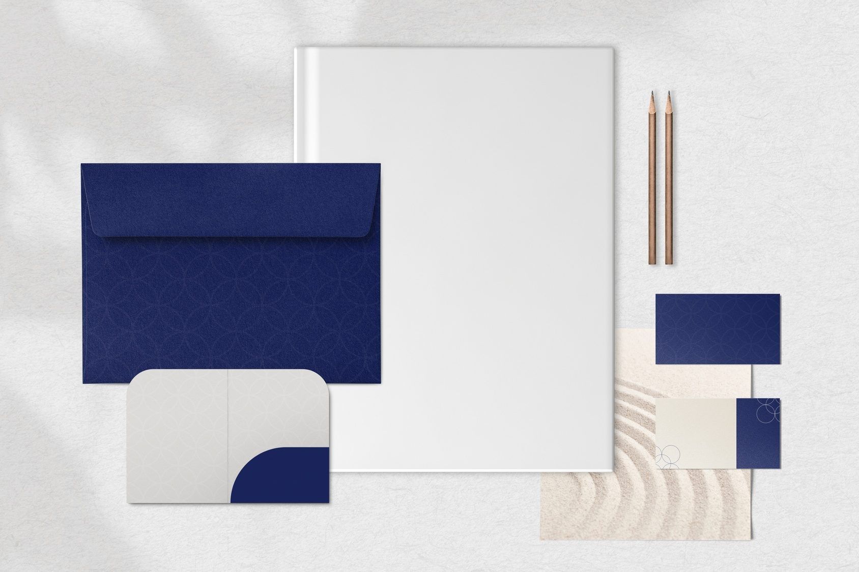 Brand identity mockups on business cards and stationery